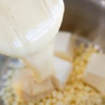 Pouring sweetened condensed milk into pot