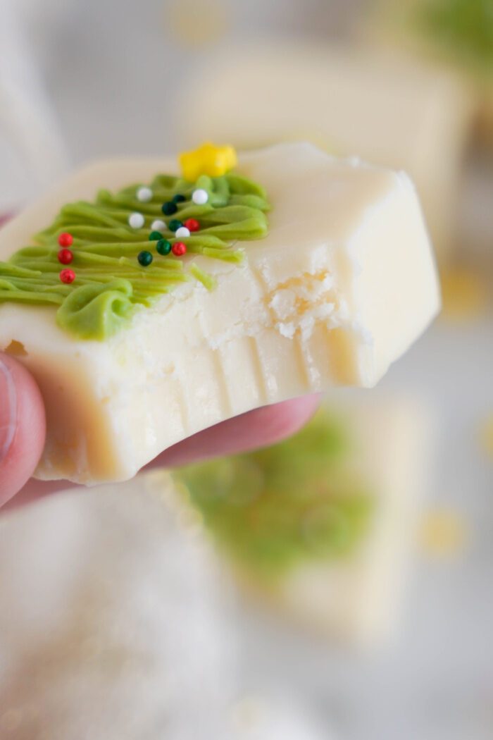 Vanilla Christmas fudge square with a bite taken out of it