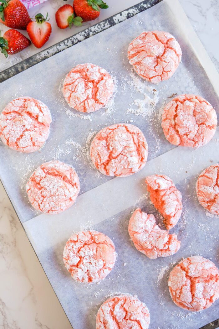 Baked Strawberry Crinkle Cookies on baking sheet