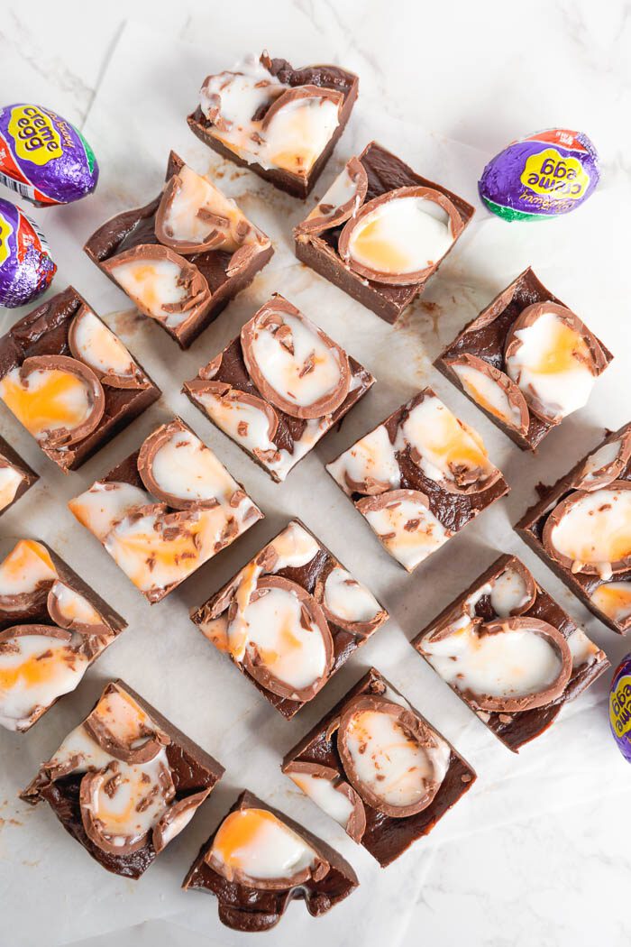 Squares of chocolate fudge with yellow and white filling.