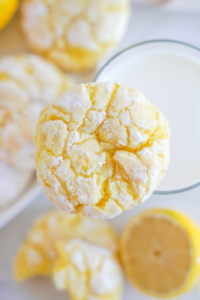 Lemon Crinkle Cookie on top of glass of milk