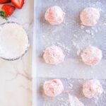 Strawberry cookie dough balls on a baking sheet