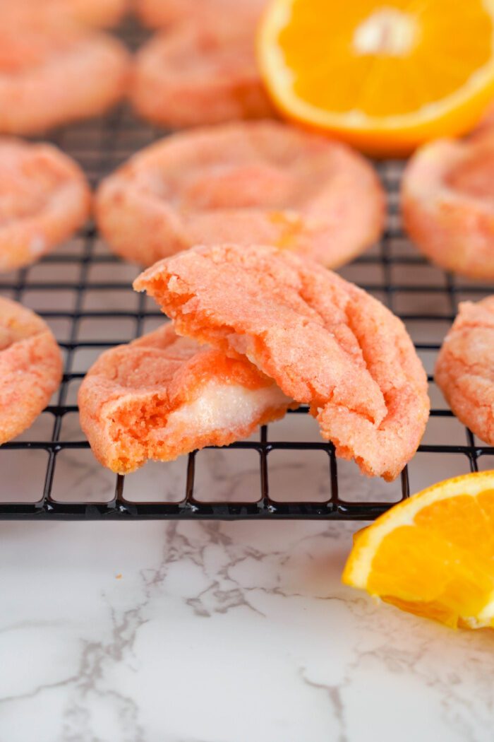 Creamsicle Orange Cookie broken in half on cooling rack