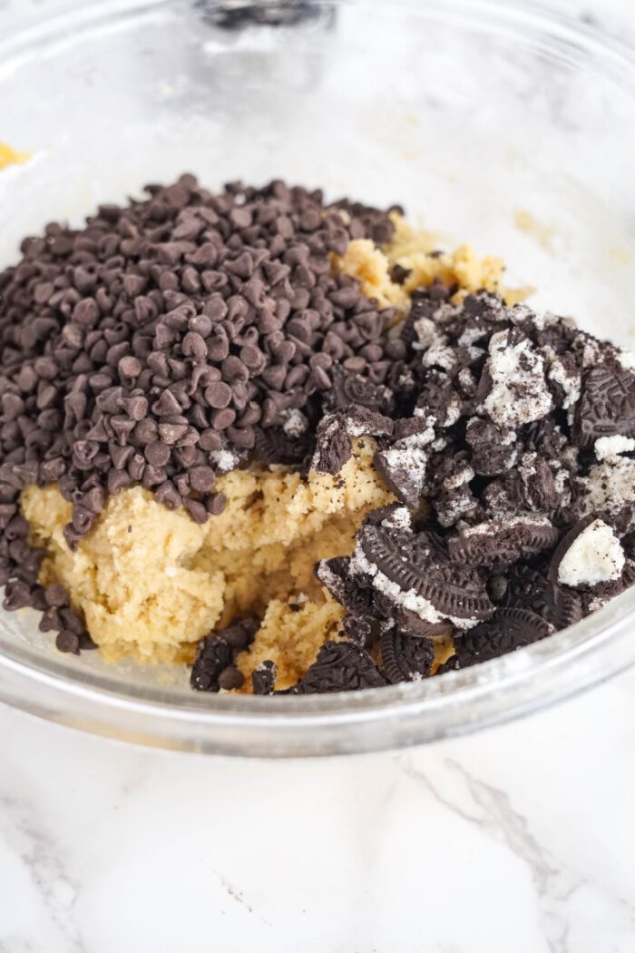 Crushed oreos and chocolate chips added to cookie mix