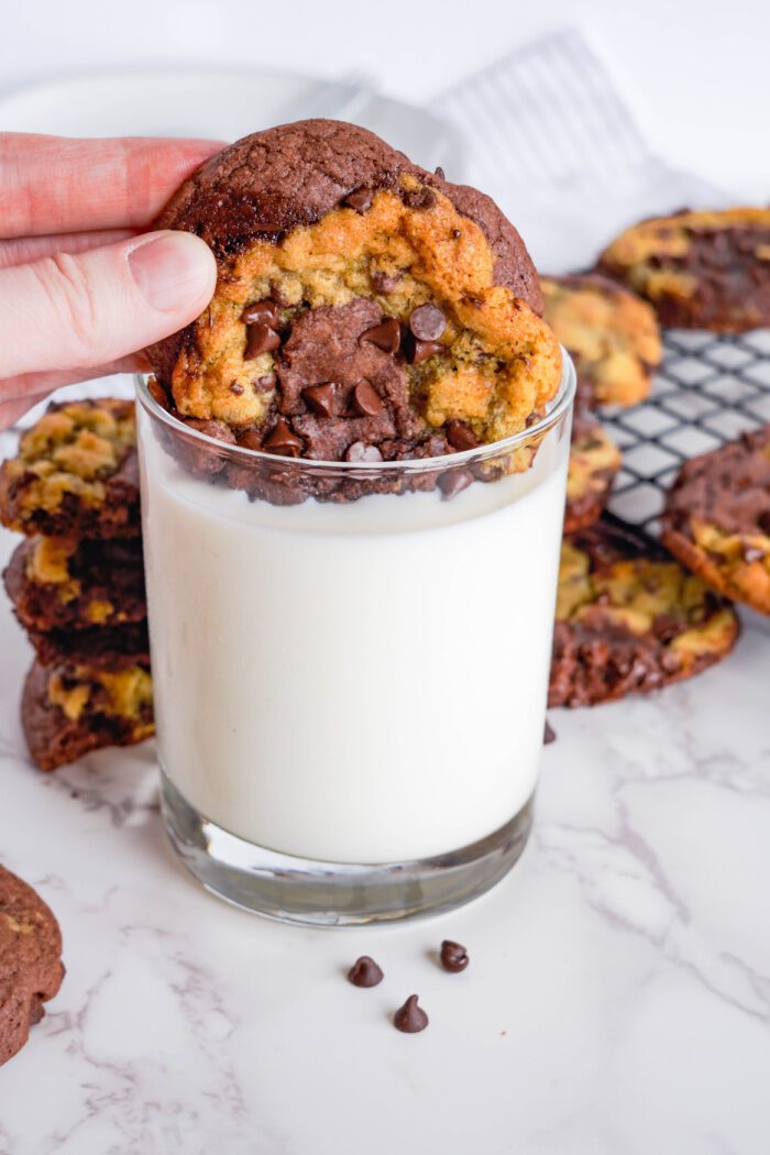 Brookie Cookie being dipping into glass of milk