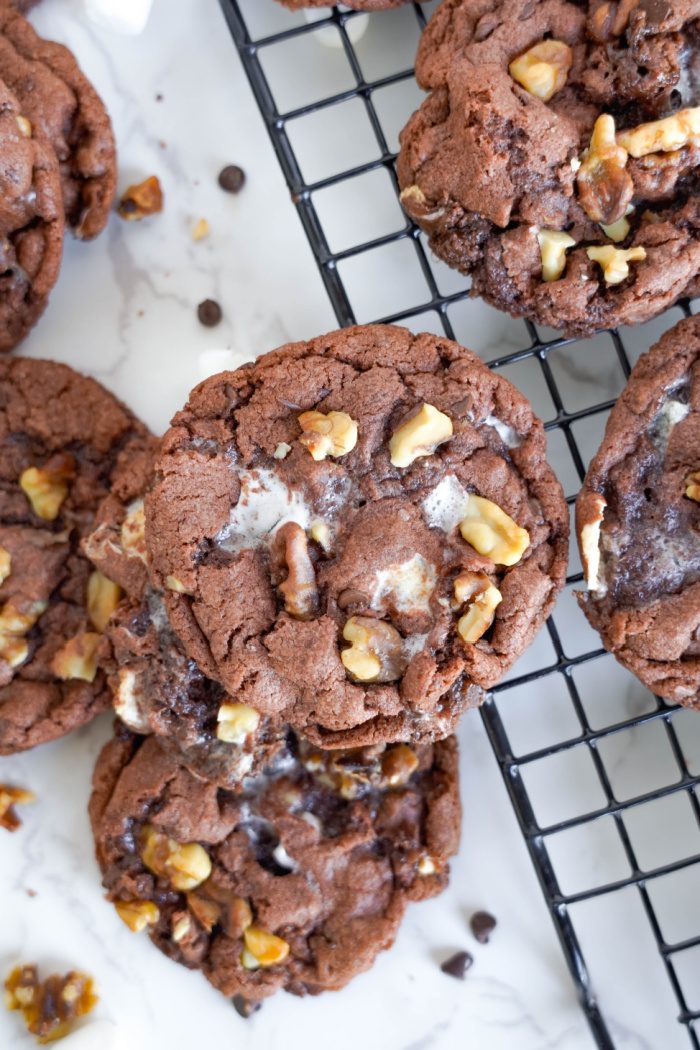 Several Rocky Road cookies on and off cooling rack