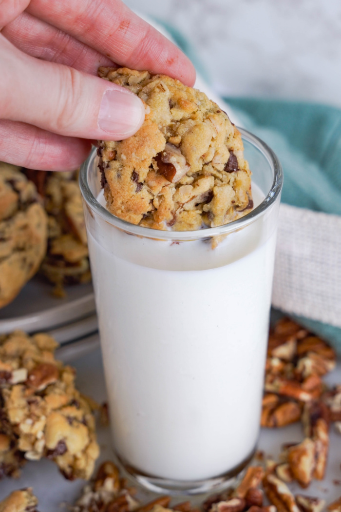Oatmeal Chocolate Chip Cookie dunked into glass of milk