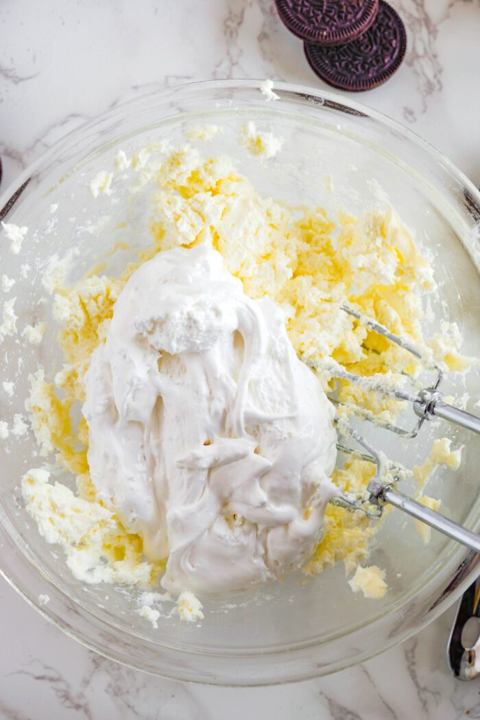 Easy Oreo Cookie Dip adding in marshmallow fluff