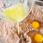 Candy Bar Brownie Cookies adding eggs and butter into bowl