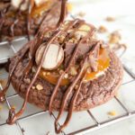 Candy Bar Brownie Cookies being drizzled with chocolate