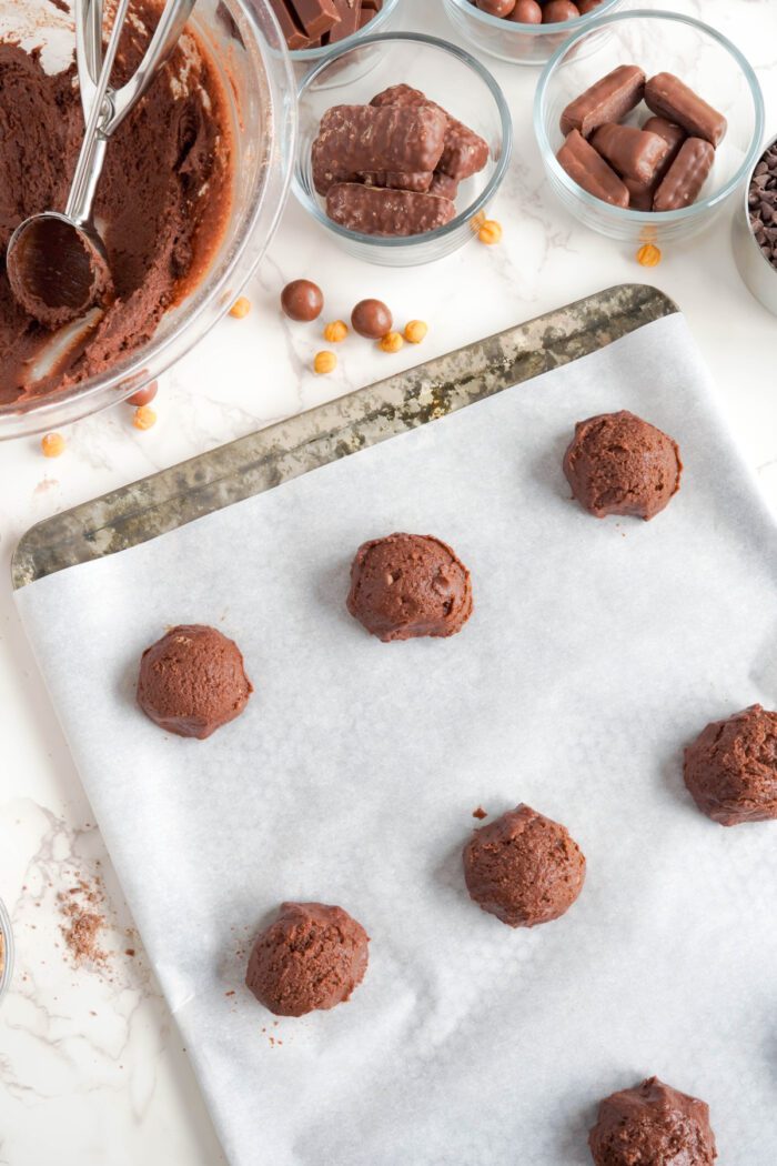 Candy Bar Brownie Cookies dough balls on baking sheet