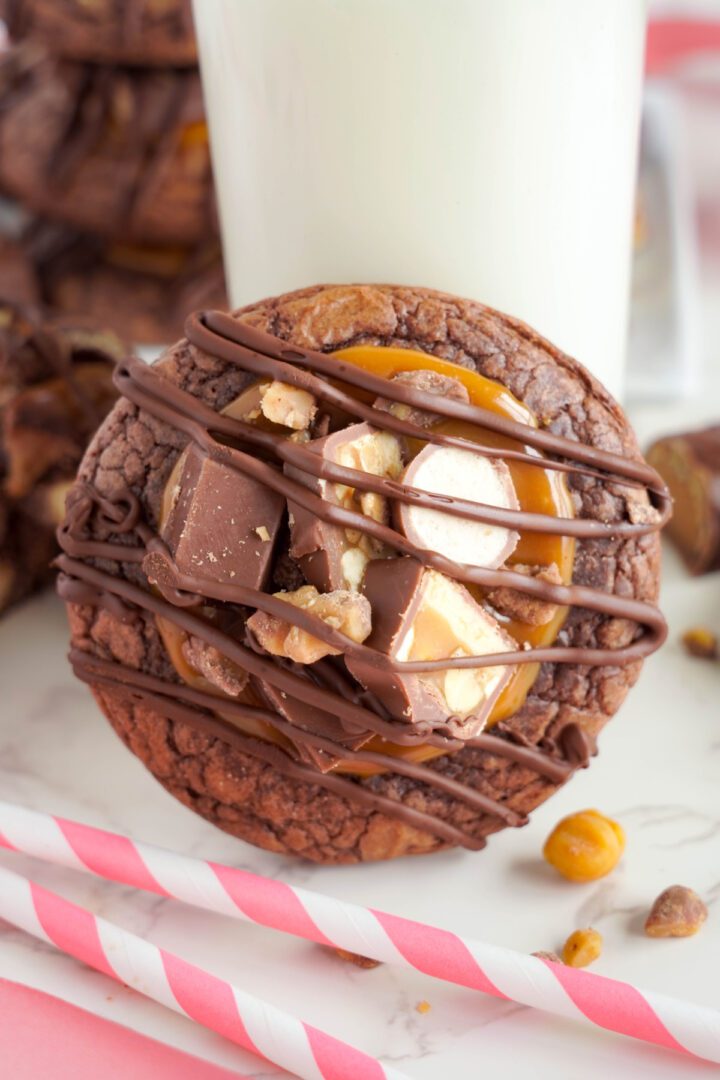 Chocolate Bar Cookies propped up on glass of milk
