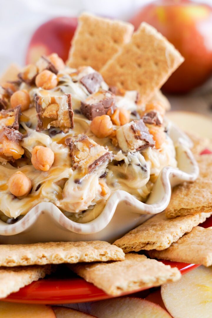 Snickers Apple Dip in a bowl with graham crackers