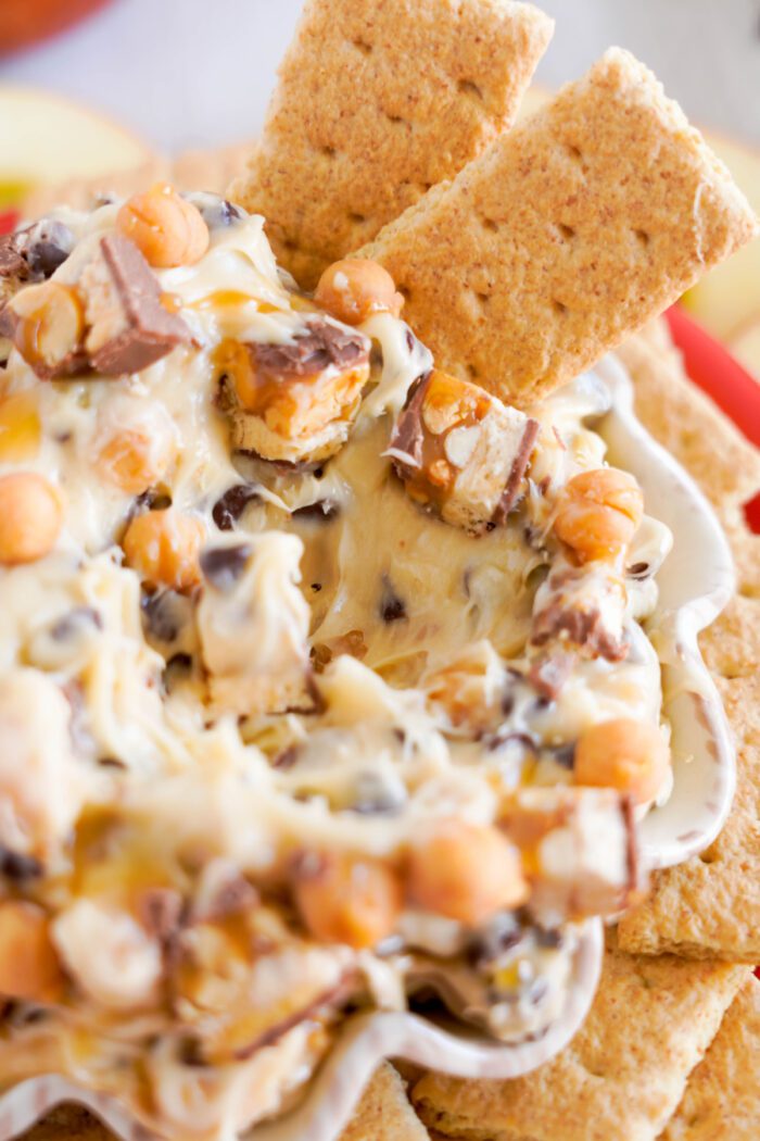 Snickers Dip with graham crackers dipped into it