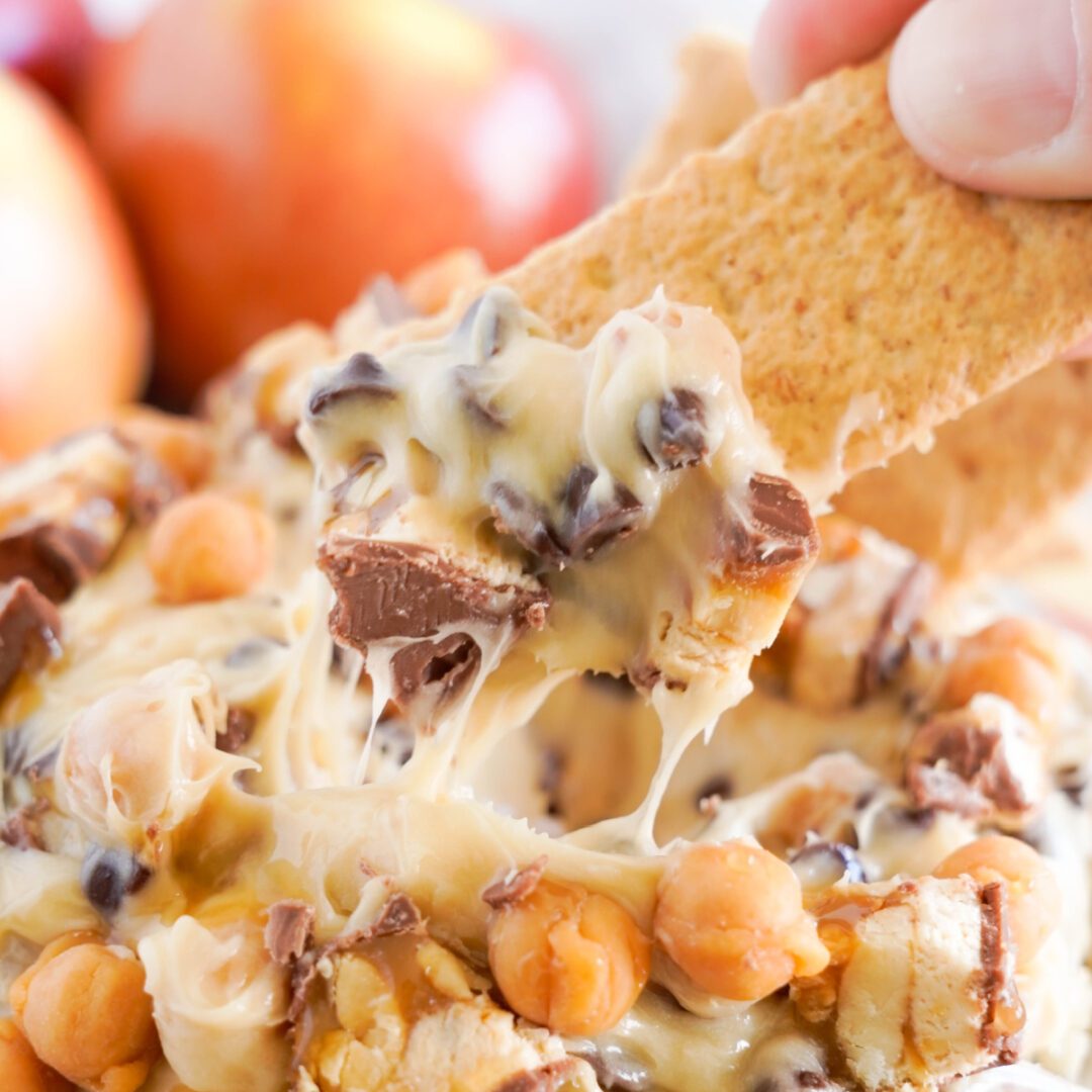Snickers Caramel Apple Dip Recipe being dipped with graham crackers