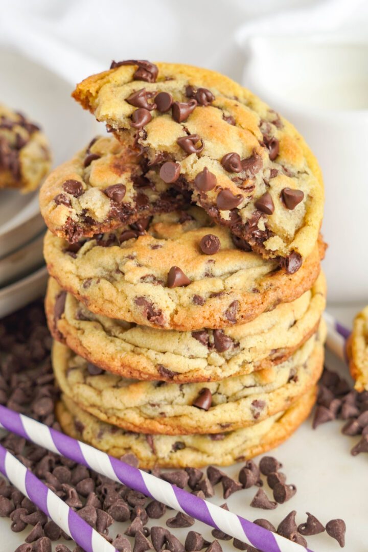 Thick and Chewy Chocolate Chip Cookies stacked with the top one broken in half