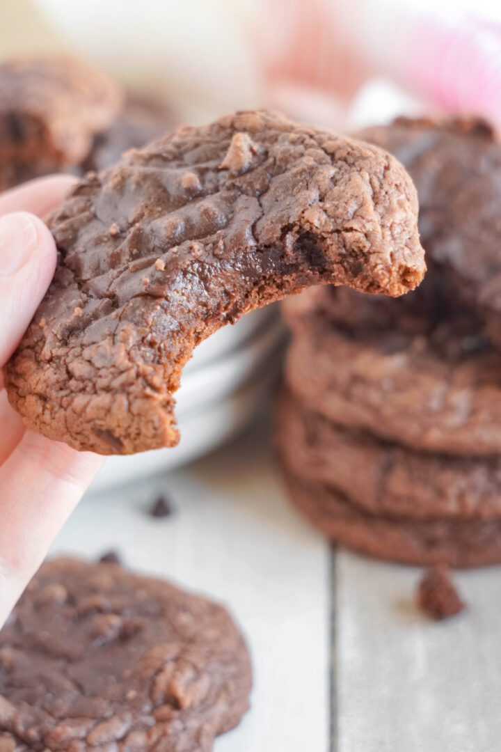 Easy Brownie Mix Cookies being held with a bite taken out