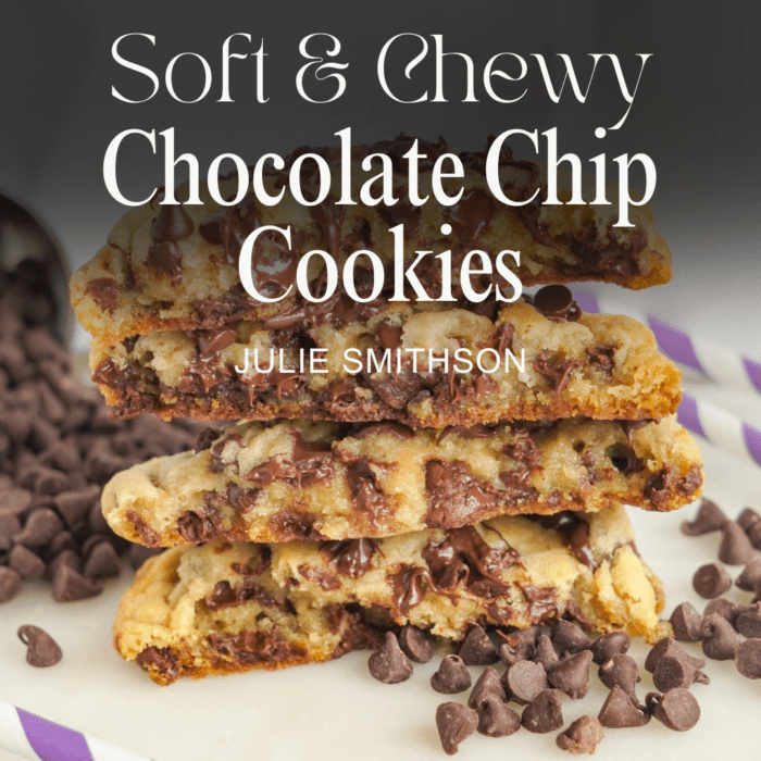 A stack of thick and chewy chocolate chip cookies, broken in half to reveal the gooey interior. Scattered chocolate chips surround the cookies. Text overlay reads: "Thick & Chewy Chocolate Chip Cookies - Julie Smithson.