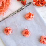 Strawberry Cake Mix Cookie dough balls topped with strawberries