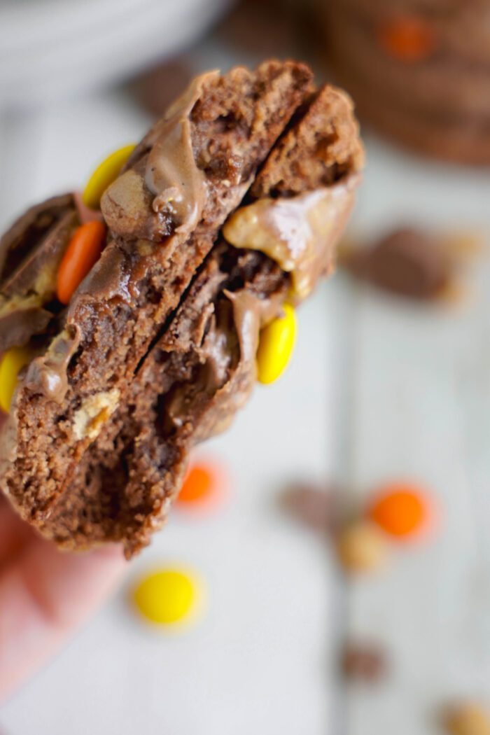 Reese's Brownie Mix Cookie being held and broken in half