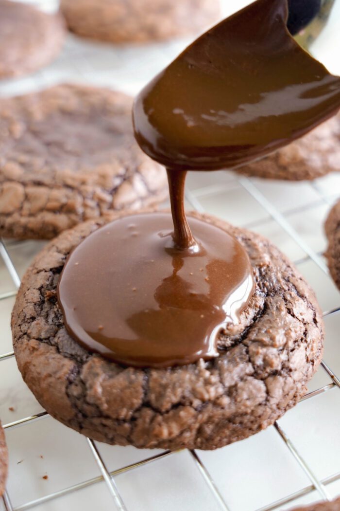 Cosmic Brownies Cookies being topped with chocolate glaze