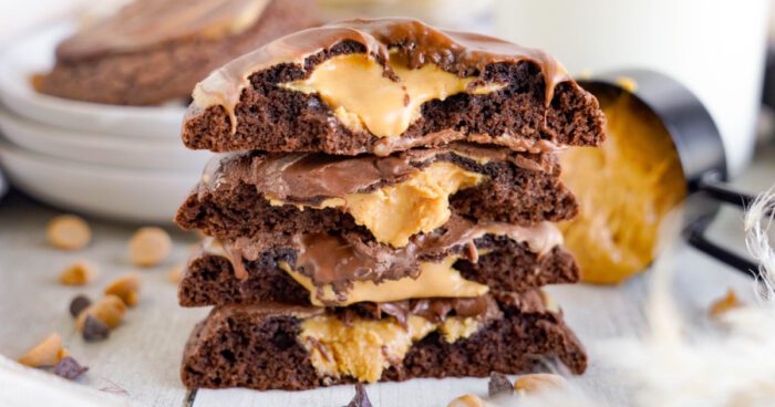 A stack of three chocolate cookies with peanut butter filling.