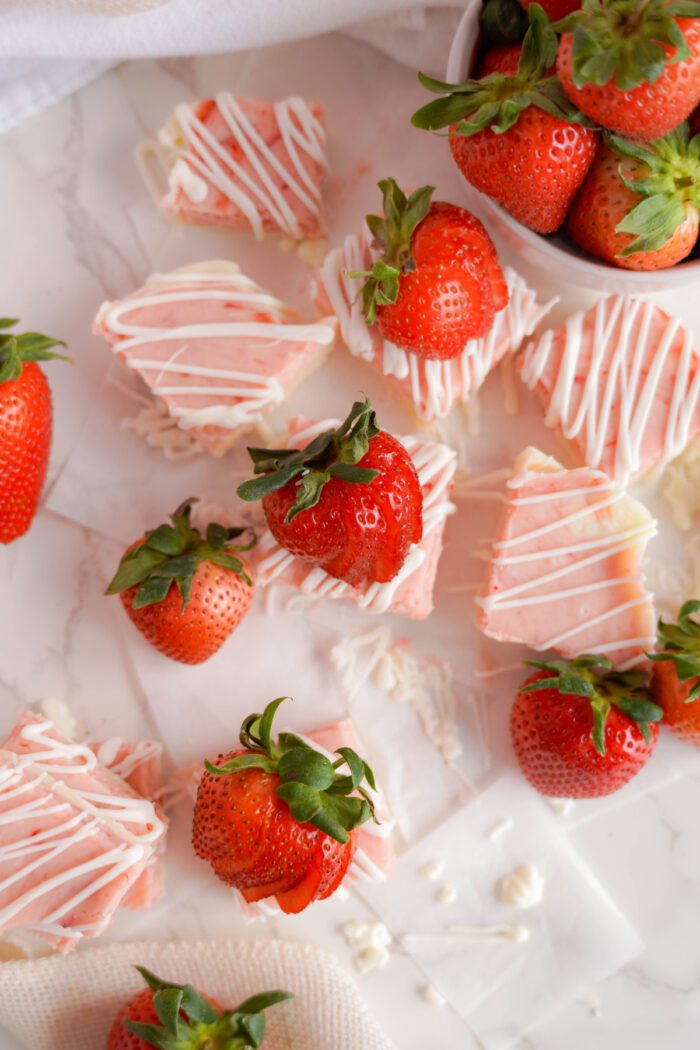 Strawberry Swirl Fudge drizzled with almond bark and topped with strawberries