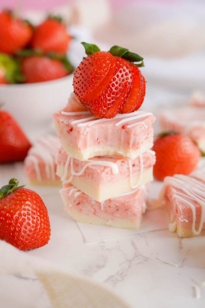 Strawberry Swirl Fudge stacked squares with strawberry on top