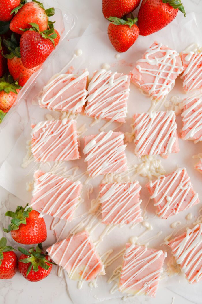 Strawberry Fudge cut into squares and drizzled with almond bark