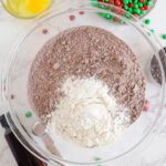 Christmas M&M Chocolate Brownie Cookies adding chocolate chips and M&Ms