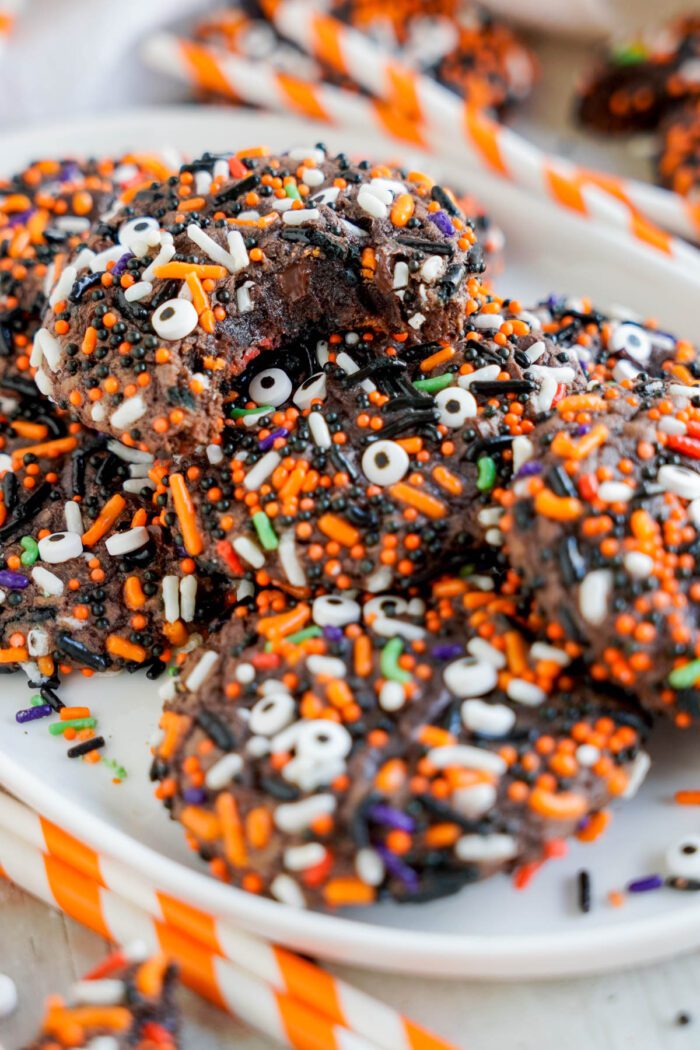 A close-up image of a plate of Halloween-sprinkled chocolate cookies.