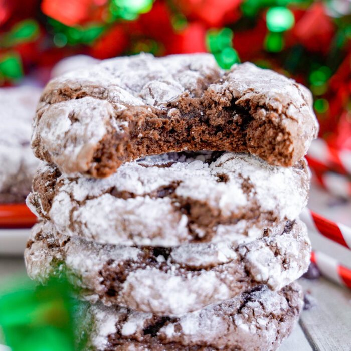 Chocolate Christmas Crinkle Cookies stacked with a bite taken out