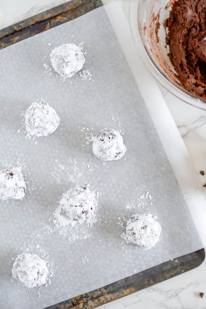 Chocolate Crinkle Cookie dough balls on baking sheet