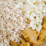 Pumpkin Oatmeal Cookie dough adding oats and white chocolate chips