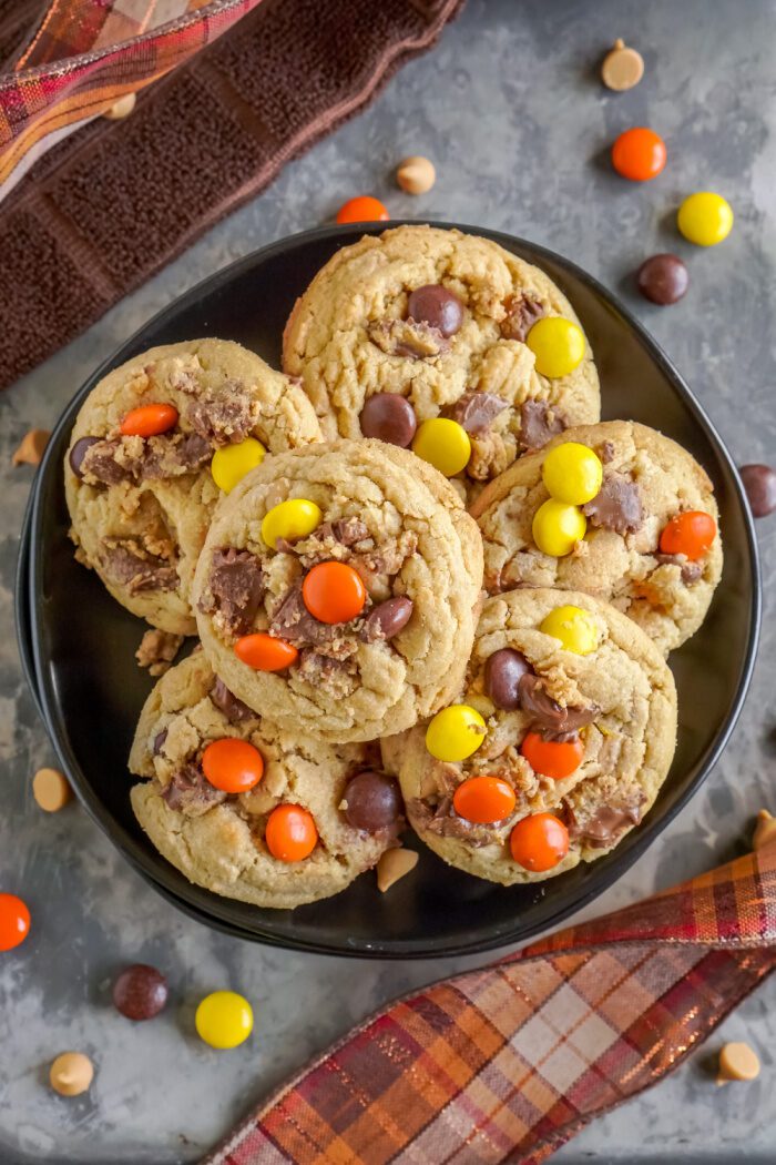 A plate of peanut butter cookies with Reese's Pieces.