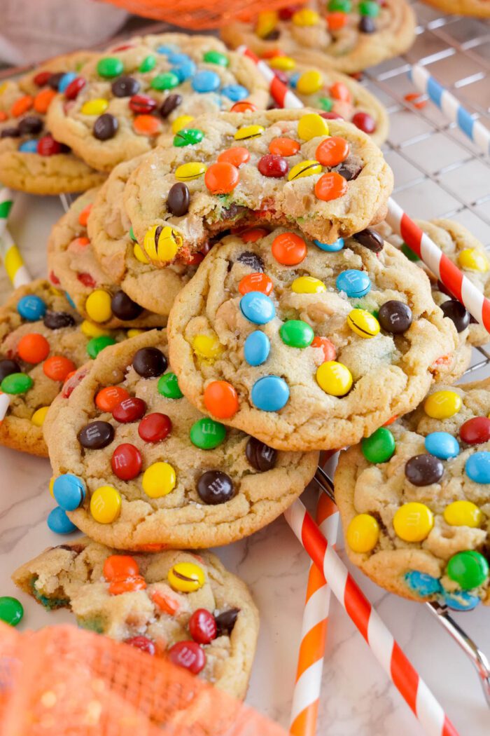 Best colorful candy-coated chocolate pieces embedded in freshly baked peanut butter cookies on a cooling rack.