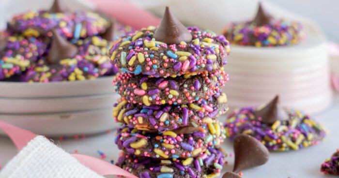 A stack of chocolate cookies with sprinkles on top.