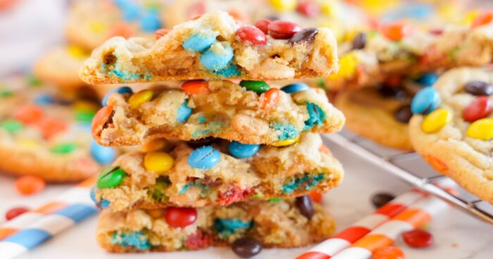 Best colorful candy-studded peanut butter cookies stacked on a wire cooling rack.