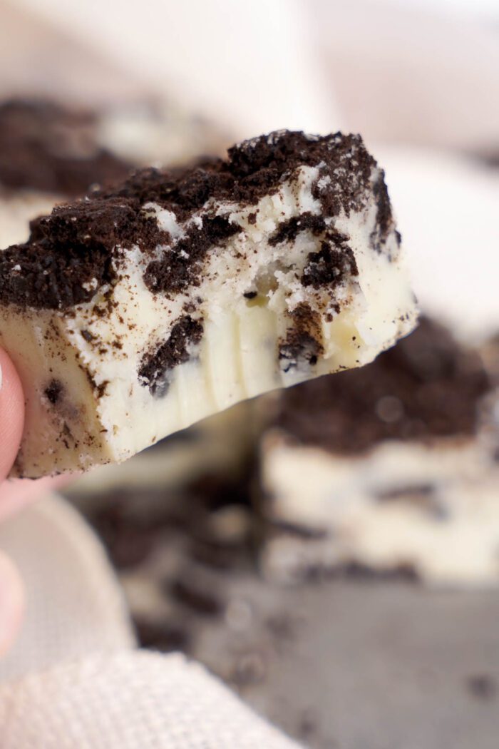 Close-up view of an Oreo fudge piece with crushed cookies on top.