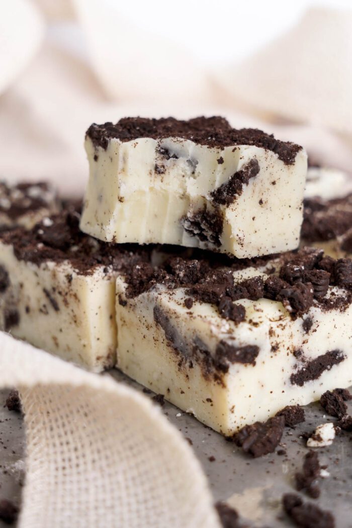 Close-up of Oreo fudge pieces with crushed cookie topping.