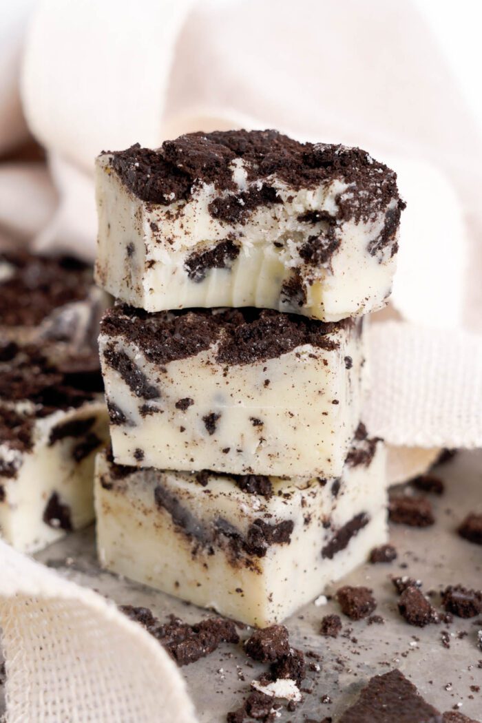 Stack of Oreo fudge pieces with cookie crumbles around.