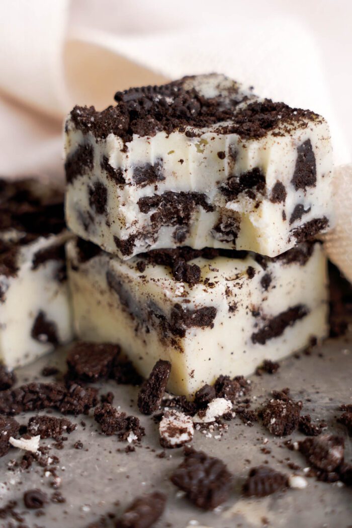 Stack of Oreo fudge pieces sprinkled with crushed cookies.