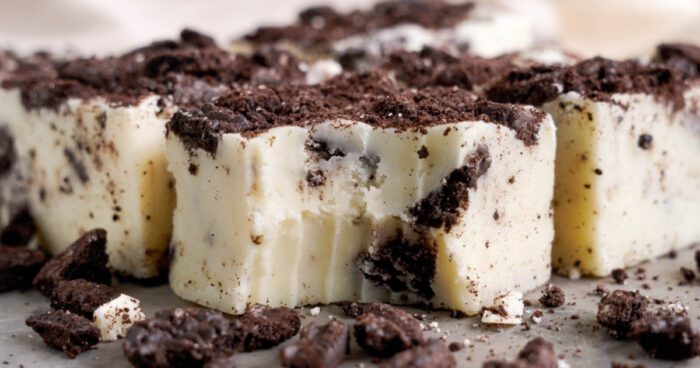 A close-up view of an Oreo fudge piece surrounded by cookie crumbles.