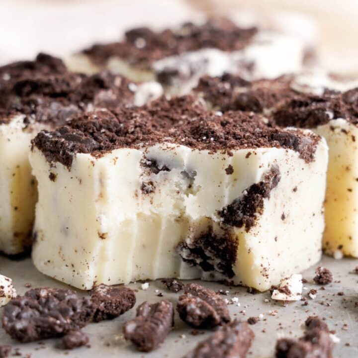 A close-up of Oreo fudge pieces with cookie crumbles on top.