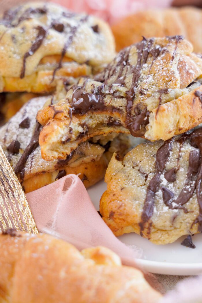 Cookie Croissants on Platter with bite out with chocolate drizzle and melty chocolate