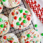 Christmas Cake Mix Cookies dipped in white chocolate and topped with sprinkles and M&Ms