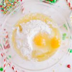 Christmas Cake Mix Cookies with cake mix, eggs, and butter in bowl