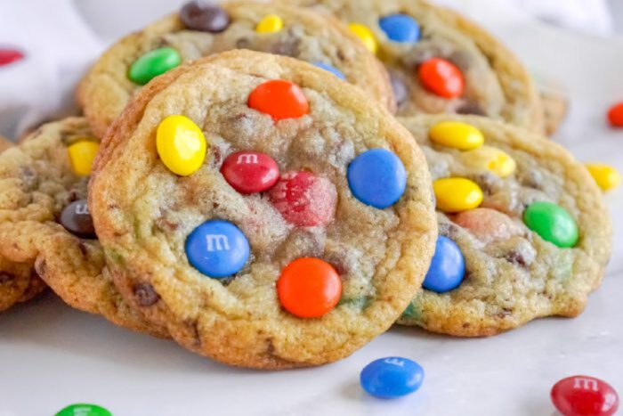 A plate of cookies topped with colorful M&M candies is shown.