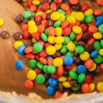 Peanut Butter Fudge Recipe adding M&Ms to fudge batter