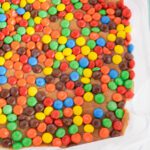 Peanut Butter Fudge Recipe topping fudge with M&Ms